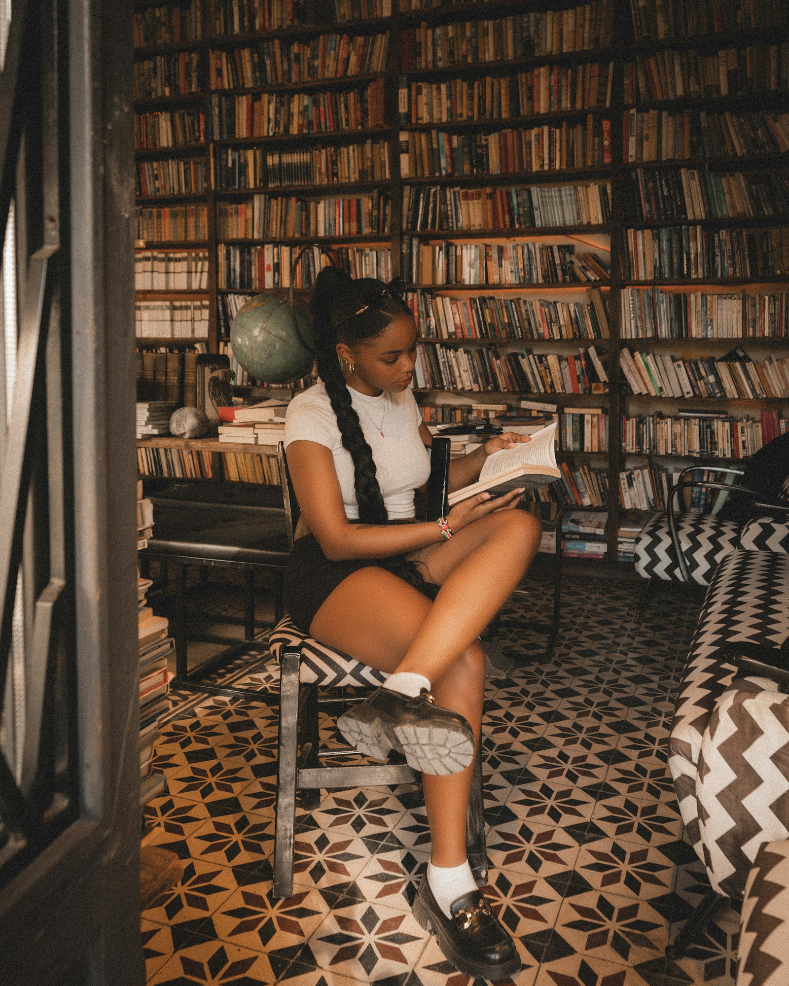 Reader surrounded by books in a library